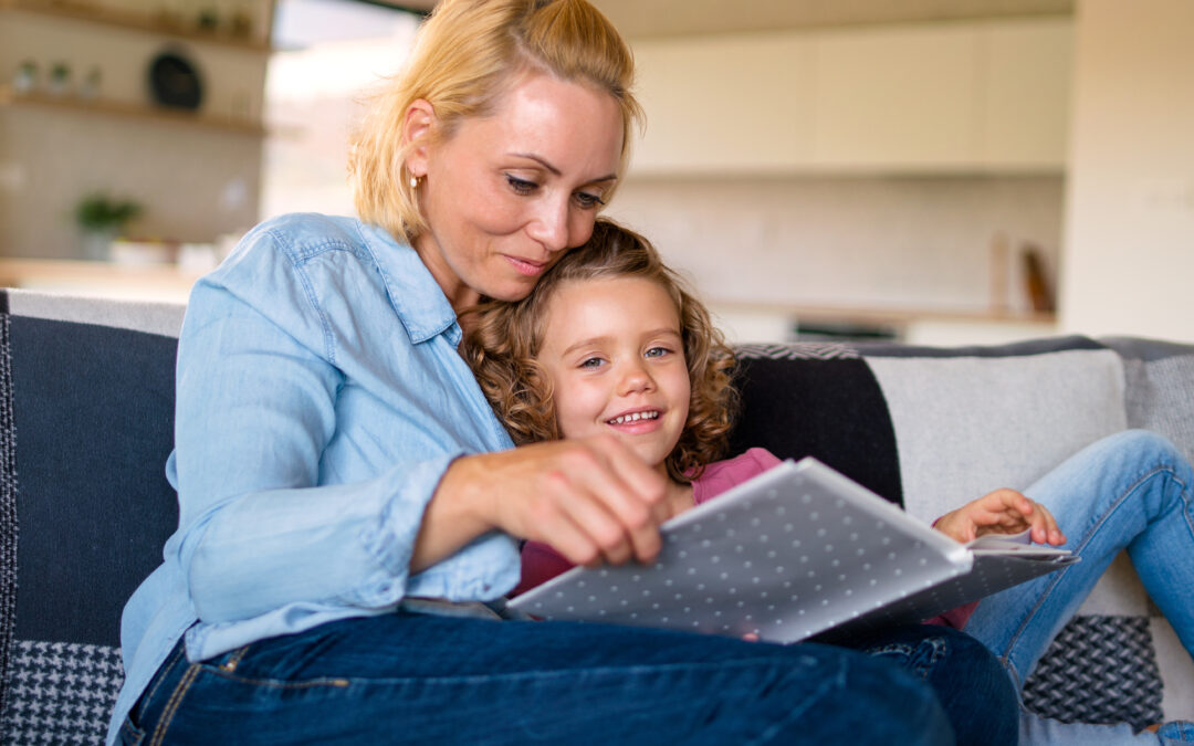 mom reading aloud daughter