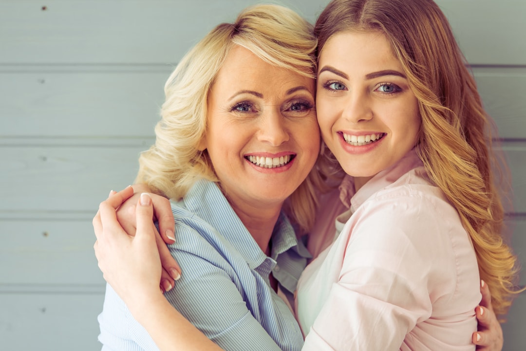 Portrait,Of,Beautiful,Mature,Mother,And,Her,Daughter,Hugging,,Looking
