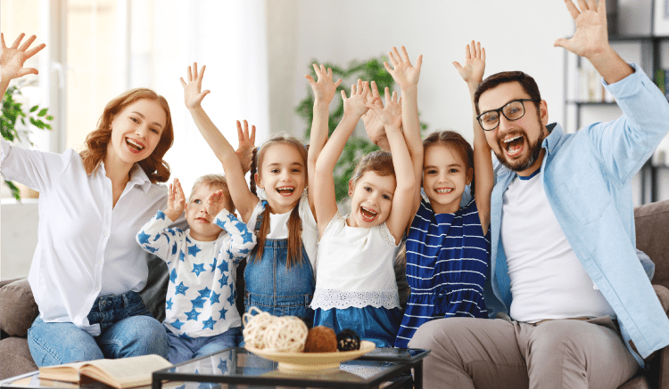 Catholic homeschool family having fun in living room