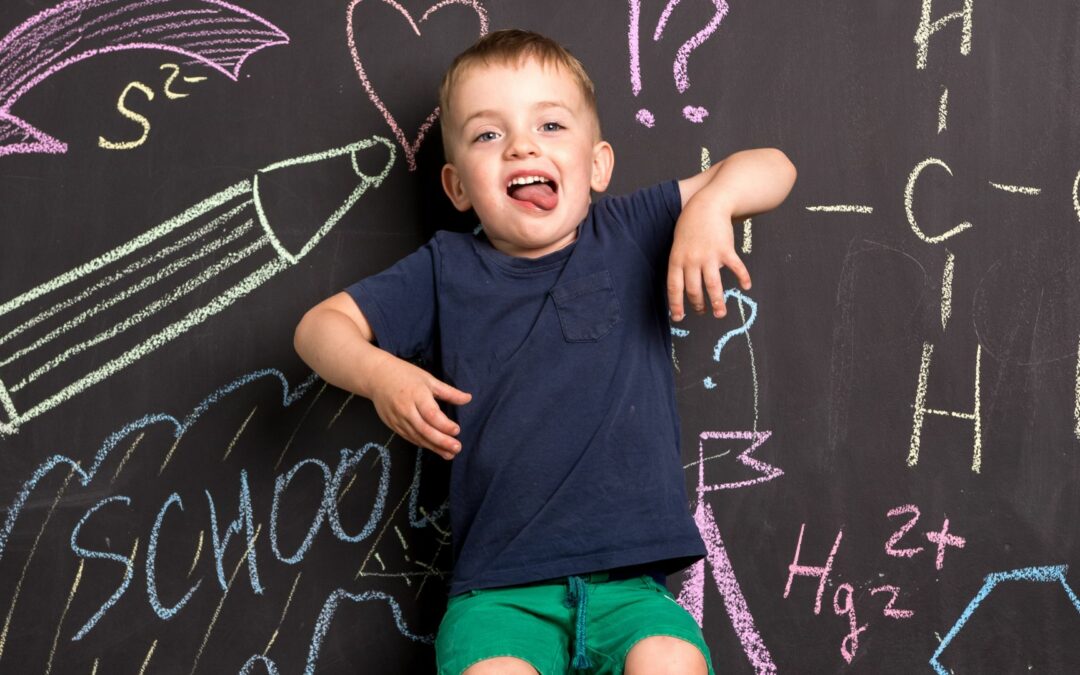 little boy and homeschool chalkmoard
